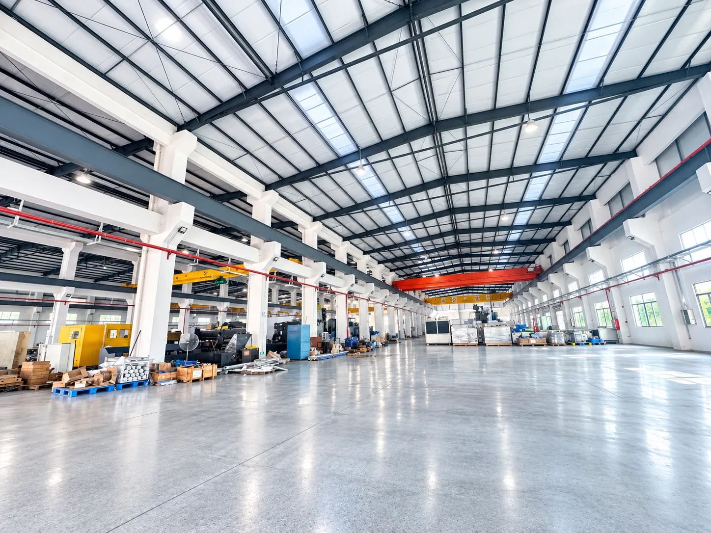 Interior of MINGXU's Dongguan manufacturing workshop, featuring spacious production facilities and overhead cranes for precision press manufacturing.